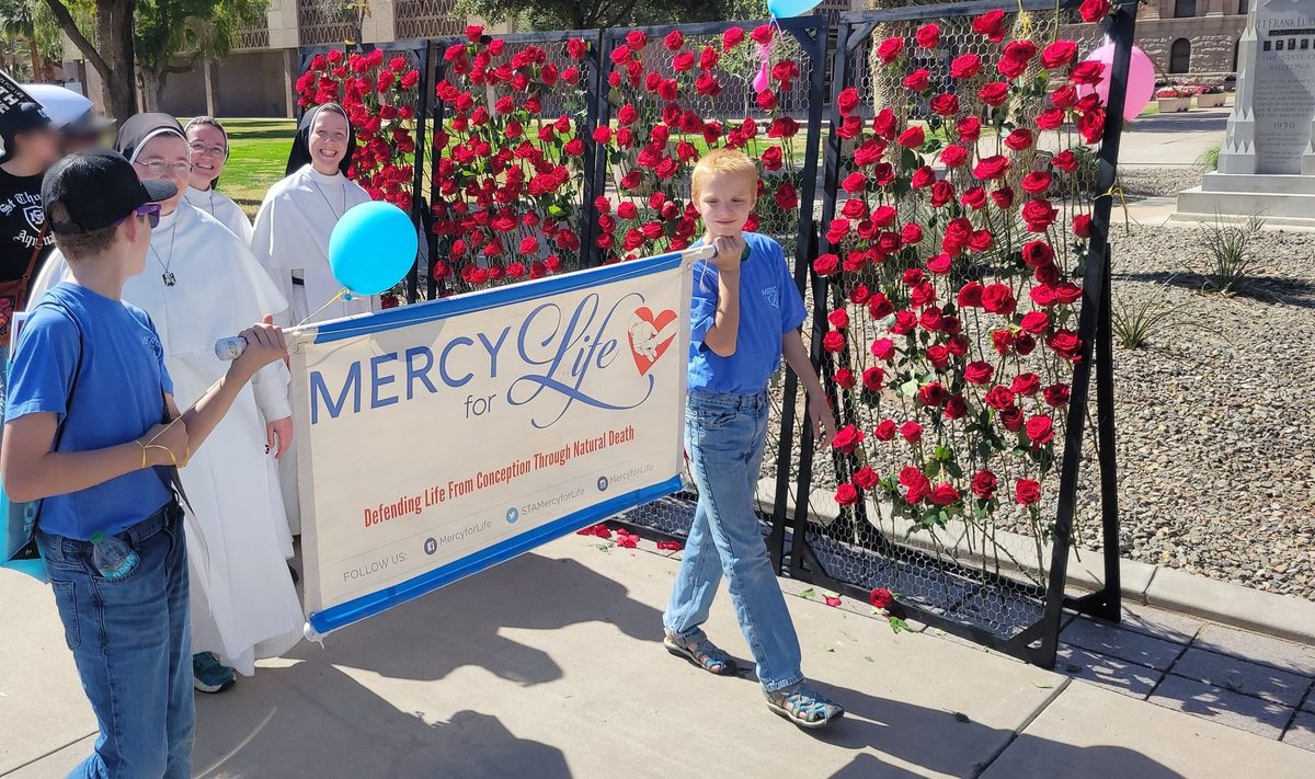 Young people carry the Mercy for Life banner alongside religious sisters at the 2026 Arizona March for Life